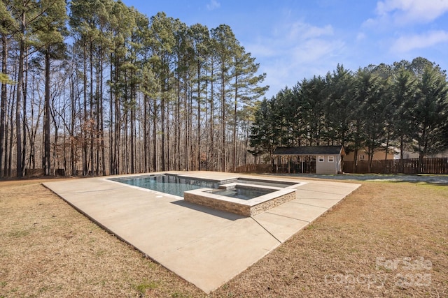 view of swimming pool with a lawn, a shed, a patio, and an in ground hot tub