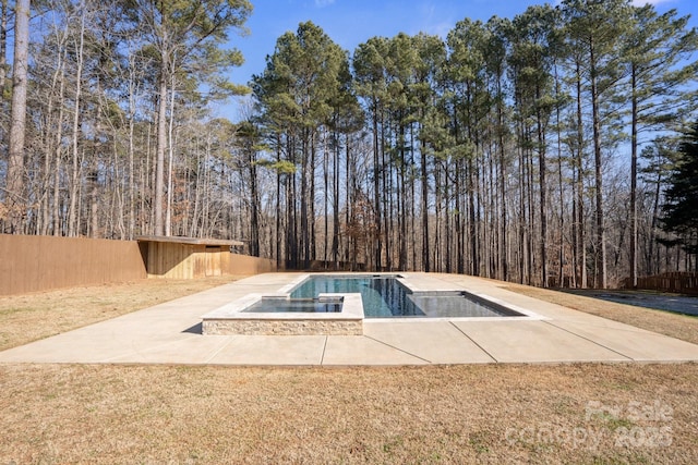 view of pool with a patio area and a lawn