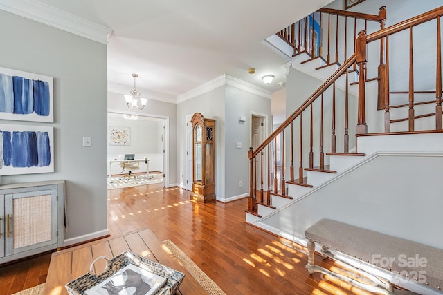 foyer featuring an inviting chandelier, crown molding, and hardwood / wood-style flooring