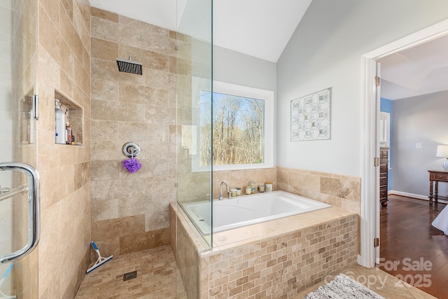 bathroom with separate shower and tub and vaulted ceiling