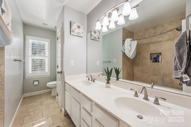 bathroom with toilet, vanity, and walk in shower