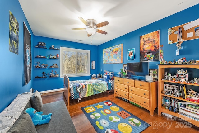 bedroom with ceiling fan and dark wood-type flooring