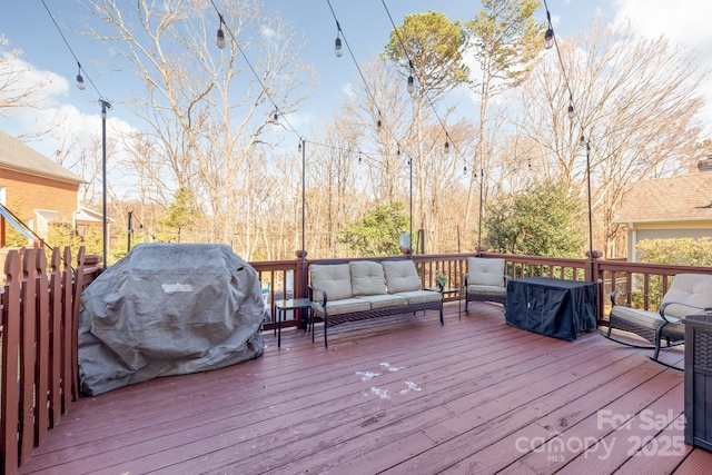 deck with area for grilling and an outdoor living space