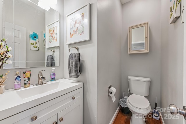 bathroom featuring hardwood / wood-style floors, vanity, and toilet