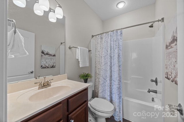 full bathroom with vanity, shower / tub combo, a textured ceiling, and toilet