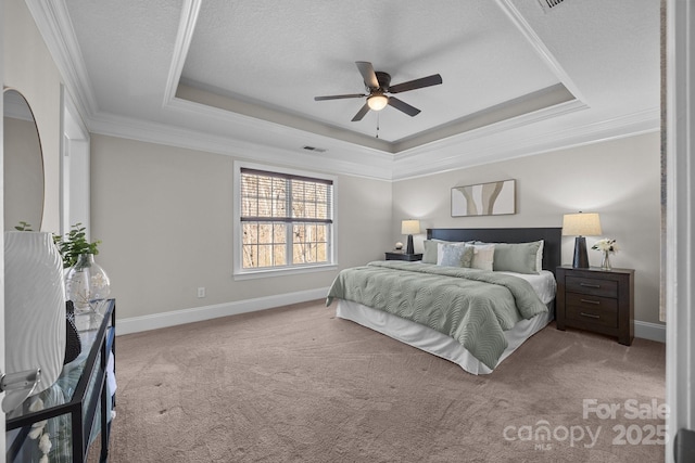 bedroom featuring crown molding, light colored carpet, and a tray ceiling