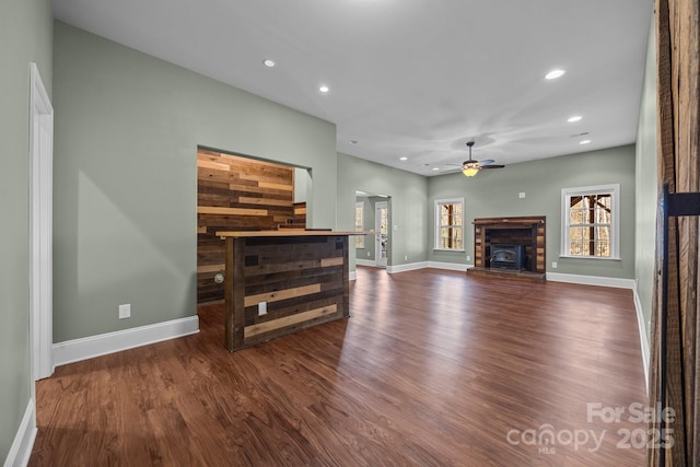 living room featuring ceiling fan and dark hardwood / wood-style flooring