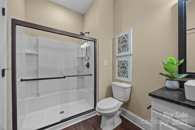 bathroom with vanity, toilet, an enclosed shower, and hardwood / wood-style floors