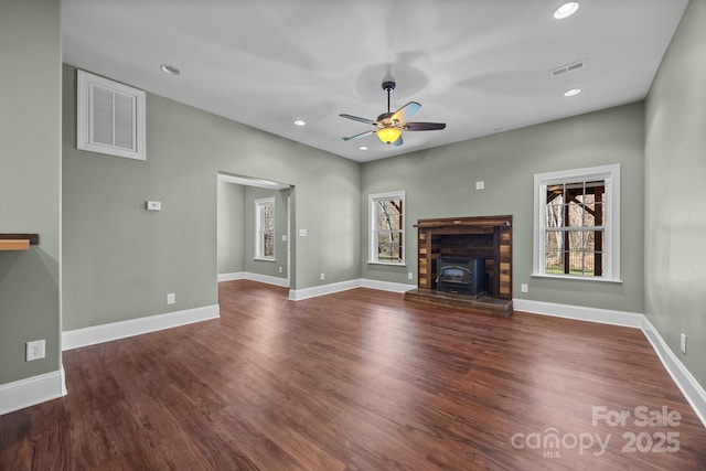 unfurnished living room featuring dark hardwood / wood-style floors and ceiling fan