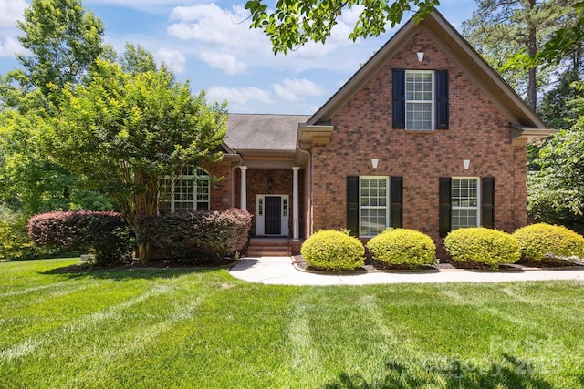 254 Streamside Pl, Mooresville, NC 28115 - traditional-style home with a front lawn, brick siding, and roof with shingles