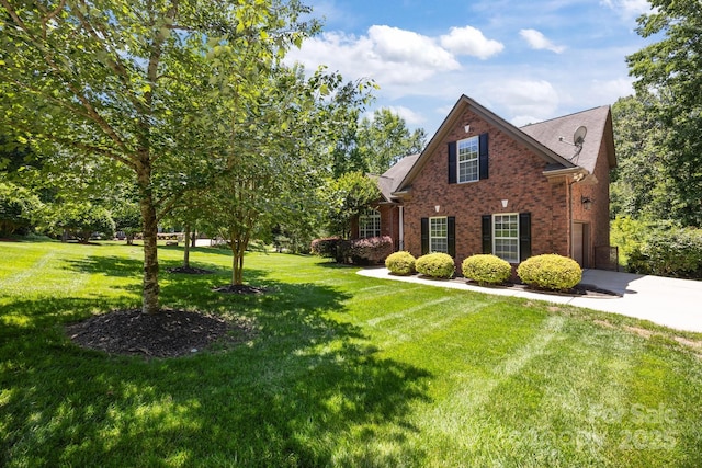 254 Streamside Pl, Mooresville, NC 28115 - view of side of property with brick siding, a yard, and driveway