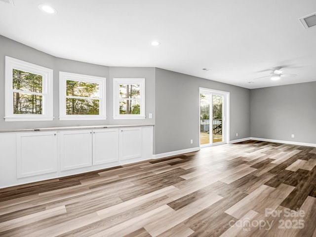 spare room featuring light hardwood / wood-style floors and ceiling fan