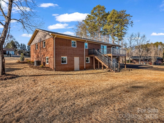 back of property with a deck and cooling unit