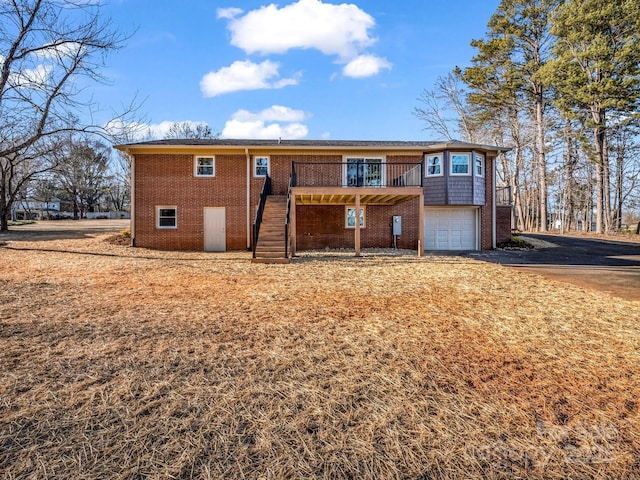 view of front of property featuring a deck and a garage