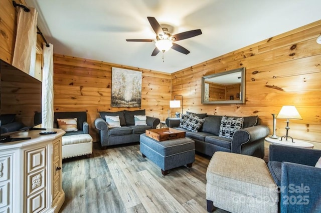 living room with ceiling fan and hardwood / wood-style flooring