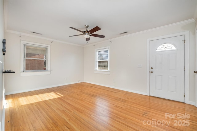 entrance foyer featuring ceiling fan, hardwood / wood-style floors, and crown molding