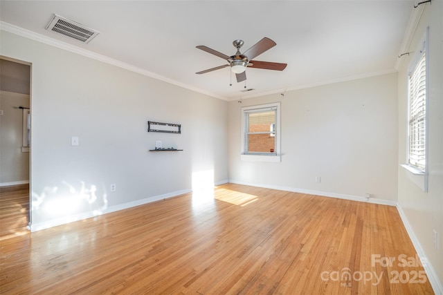 empty room featuring ceiling fan, light wood-type flooring, plenty of natural light, and crown molding