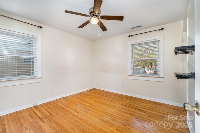 empty room featuring ceiling fan and hardwood / wood-style flooring