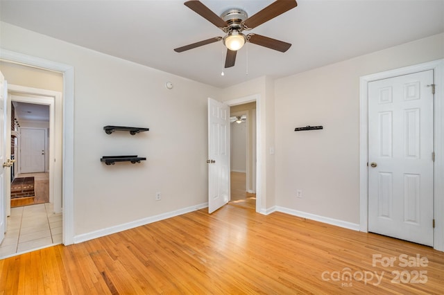 unfurnished bedroom featuring ceiling fan and light wood-type flooring