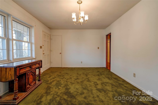 carpeted dining area featuring a chandelier