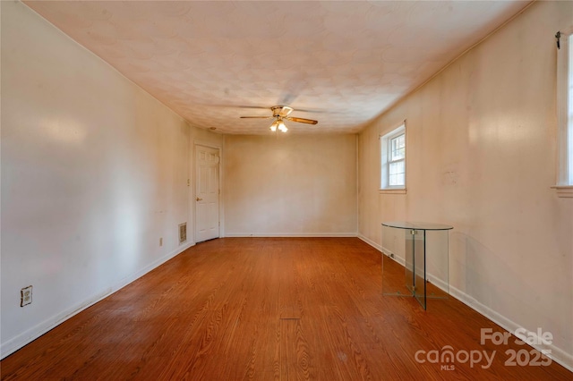 empty room featuring wood-type flooring and ceiling fan