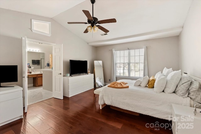 bedroom featuring ceiling fan, dark wood-type flooring, lofted ceiling, and ensuite bath