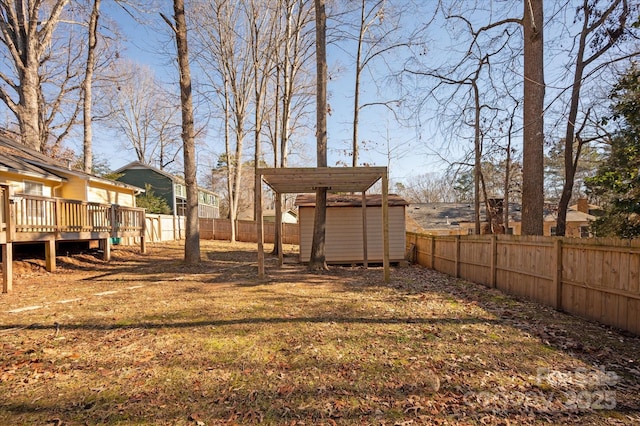 view of yard with a shed and a wooden deck