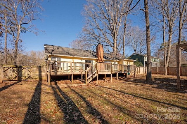 rear view of house with a wooden deck