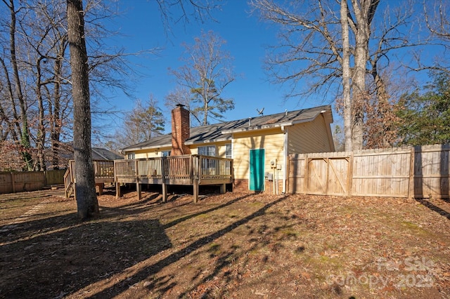 rear view of house featuring a deck