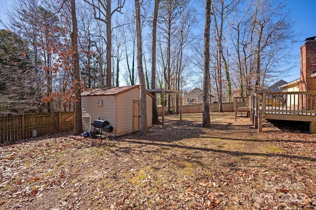 view of yard featuring a shed and a wooden deck