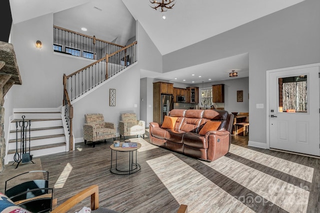 living room featuring high vaulted ceiling and dark hardwood / wood-style flooring