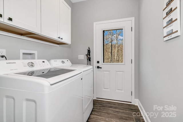 clothes washing area with washer and dryer, cabinets, and dark wood-type flooring