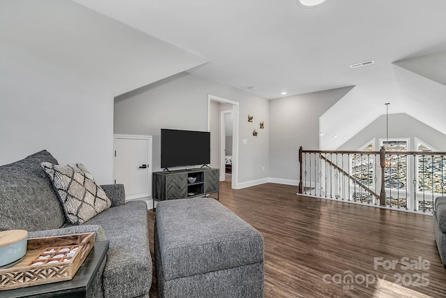 living room featuring lofted ceiling and dark hardwood / wood-style floors