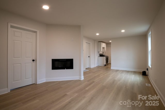 unfurnished living room featuring light hardwood / wood-style flooring