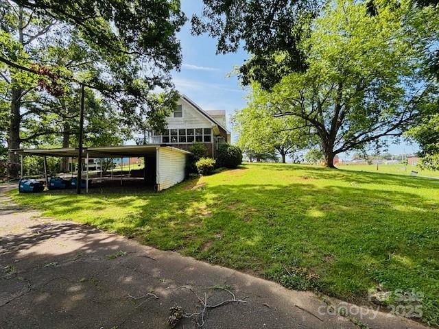266 Hudlow Rd, Forest City, NC 28043 - view of green lawn with a carport