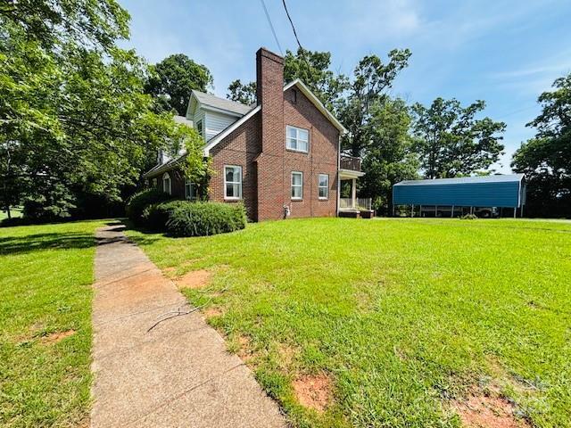 266 Hudlow Rd, Forest City, NC 28043 - view of side of property with a yard and a chimney