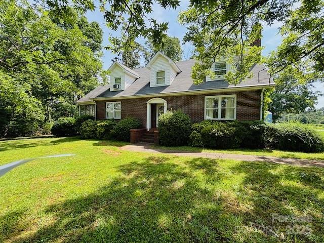 266 Hudlow Rd, Forest City, NC 28043 - new england style home with a front yard and brick siding