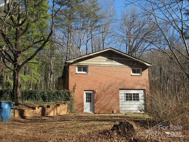 back of property with a garage