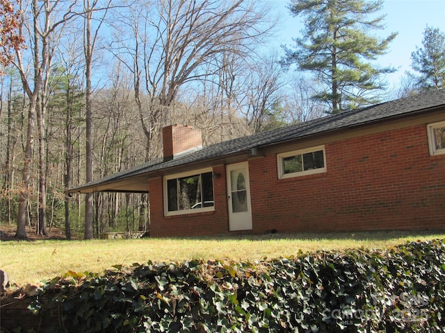 rear view of house featuring a yard