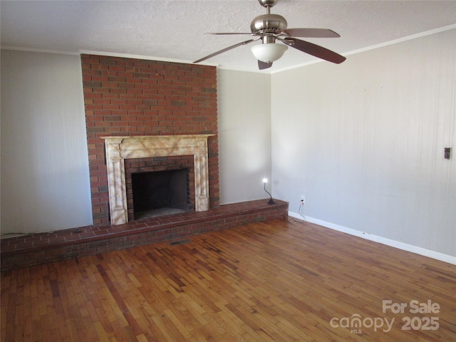 unfurnished living room with crown molding, a brick fireplace, hardwood / wood-style floors, and a textured ceiling