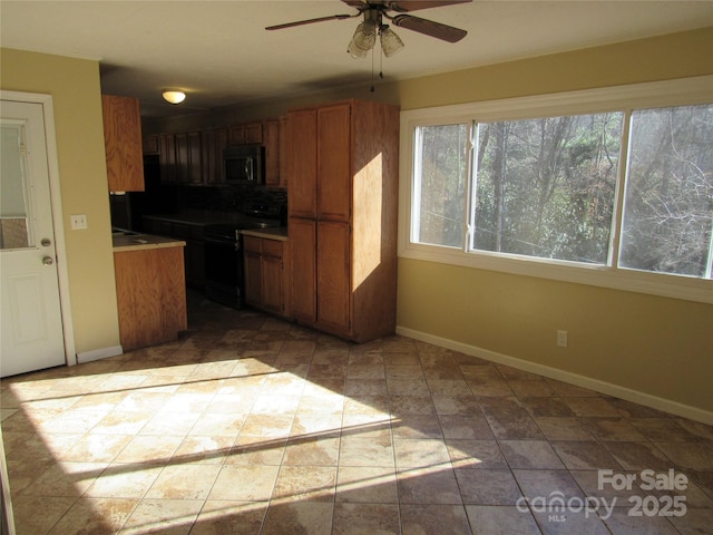 kitchen with ceiling fan and black electric range