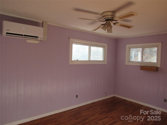 spare room with a wall mounted air conditioner, crown molding, dark hardwood / wood-style floors, and ceiling fan