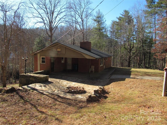 exterior space with central AC and an outdoor fire pit