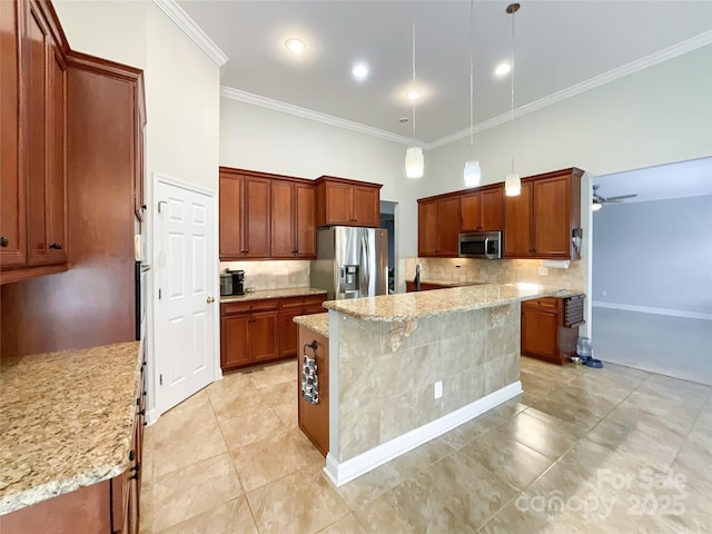 kitchen featuring a kitchen island, stainless steel appliances, hanging light fixtures, light stone counters, and crown molding