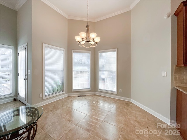 tiled dining space with an inviting chandelier and ornamental molding