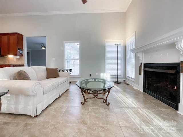 tiled living room featuring ceiling fan and crown molding