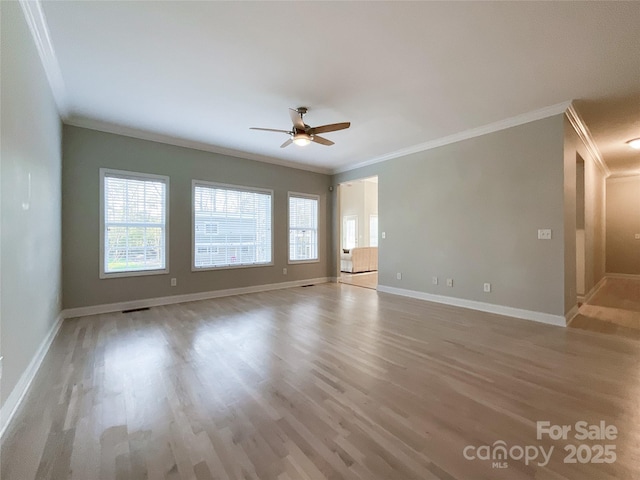 spare room featuring ceiling fan, crown molding, and light wood-type flooring