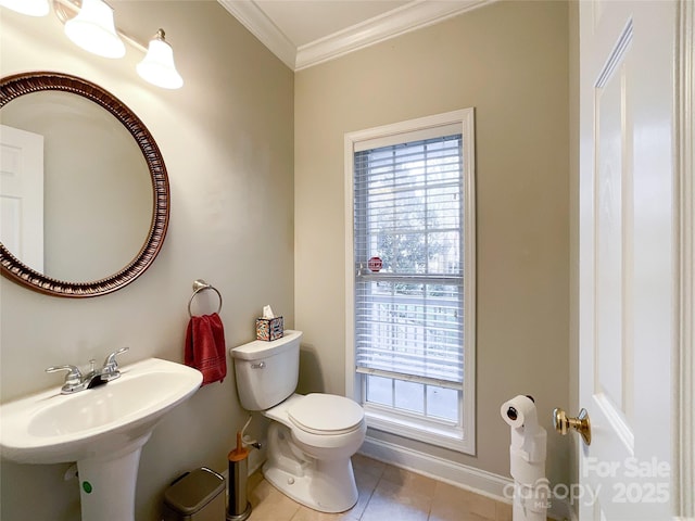 bathroom featuring toilet, crown molding, tile patterned floors, and sink