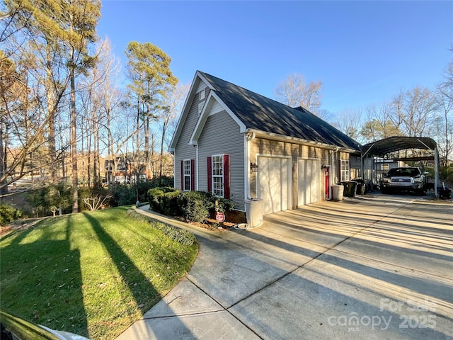 view of side of home with a carport, a yard, and a garage