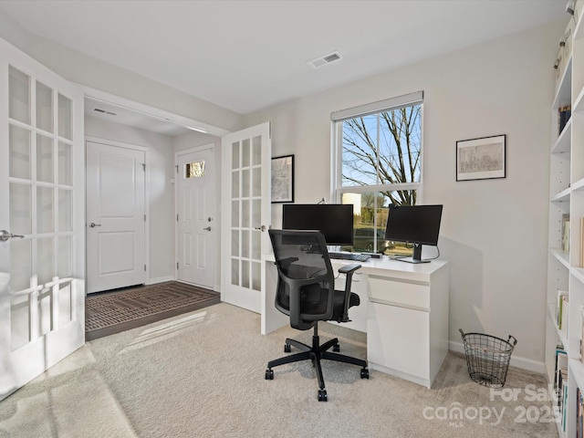 carpeted home office with french doors